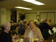 Two senior citizens sitting at a table.